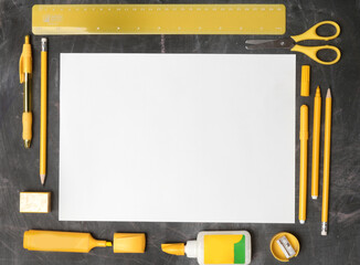 Back to school concept with variety of office and school supplies with lined blank open notebook	