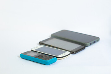 collection of mobile phones from year to year in photo from top side angle with isolated white background