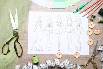 Sketch of stylish clothes and other fashion designer`s supplies on wooden table, flat lay