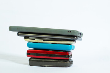 collection of mobile phones from year to year in photo from top side angle with isolated white background