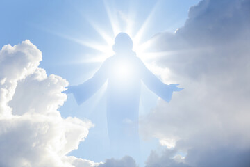 Fototapeta premium Silhouette of Jesus Christ in sunlight among clouds in sky