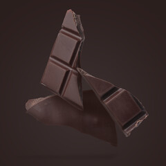 Pieces of sweet chocolate falling on dark background