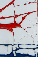 Close up photograph of an old, vibrant wall with peeling white paint. Textured background, vintage.