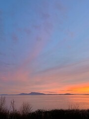 Obraz premium Sunset over the Strait of Georgia looking towards Orcas and Sucia islands, WA