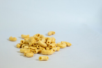 This yellow macaroni is photographed against a white background, used for commercial purposes.