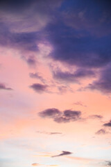 The sky is filled with clouds and the sun is setting, creating a beautiful