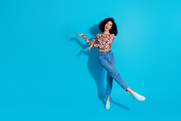 Photo of charming cheerful optimistic woman wear trendy print clothes look empty space isolated on blue color background