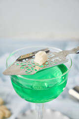Glass of absinthe with spoon and sugar cubes