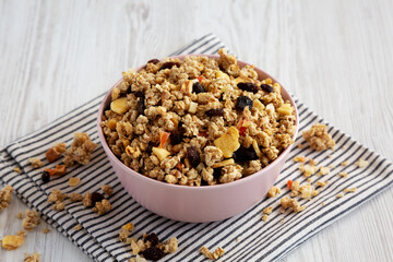 Healthy Homemade Muesli with Fruits in a Pink Bowl, side view.