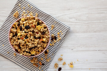 Healthy Homemade Muesli with Fruits in a Pink Bowl, top view. Copy space.