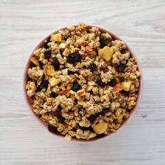 Healthy Homemade Muesli with Fruits in a Pink Bowl, top view. Flat lay, overhead, from above.