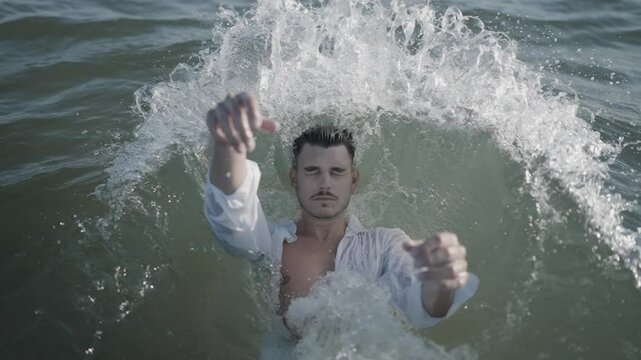 A Man Emerges Gracefully from the Water with Ethereal Elegance
