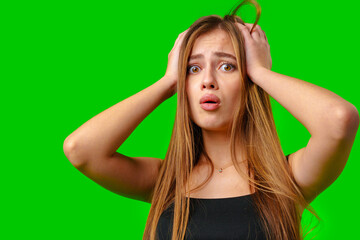 Young Woman in Black Tank Top With Hands on Head Against Green Screen Background