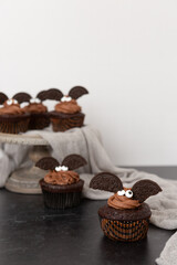 Chocolate Cupcakes Decorated like Bats for Halloween, Chocolate Frosting, Broken  Sandwich Cookies
