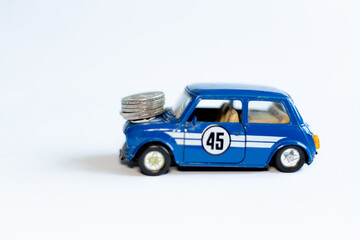 Toy car and coins. Rising prices for old cars in Ukraine