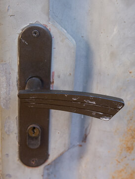 an old lock, and its handle demonstrating its importance to still lock the doors between the old and the new among the different situations of a life and a heritage