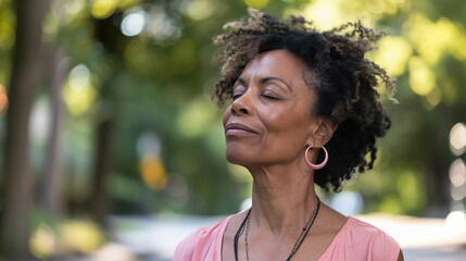 Mature black woman enjoying moment of peace, standing on summer street