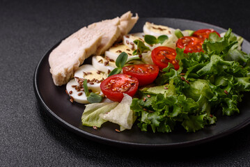 Delicious fresh caesar salad in a bowl with chicken breast, egg, tomatoes