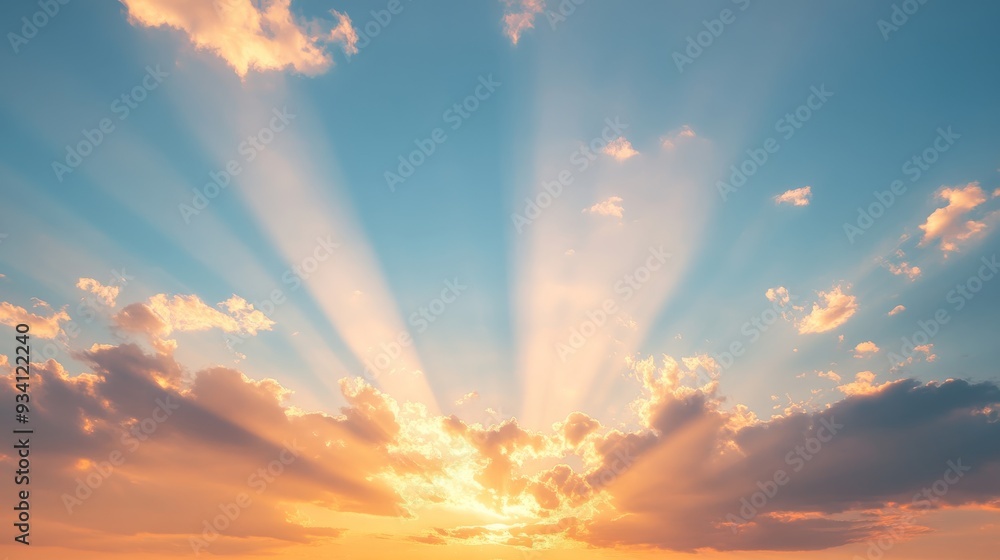 Poster sunlight bursting through scattered clouds at sunset, bathing the sky in a gradient of warm colors