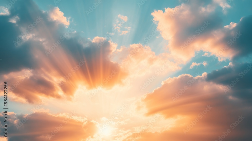 Poster sunlight bursting through scattered clouds at sunset, bathing the sky in a gradient of warm colors