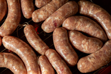 Grilled sausages on dark background.