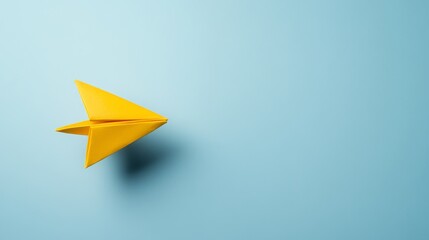 Yellow Paper Airplane Flying on a Blue Background - A simple yet powerful image of a yellow paper airplane soaring on a blue background. This represents freedom, aspiration, and the pursuit of dreams.