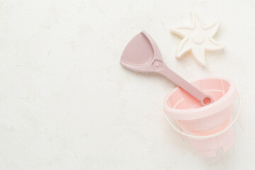 Cute toys for playing with sand on concrete background, top view