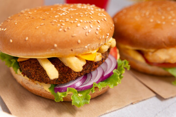 burger with beef, cheese, French fries, salad, onion, tomato 