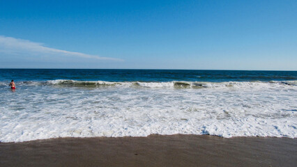 waves crashing into shore of a beach