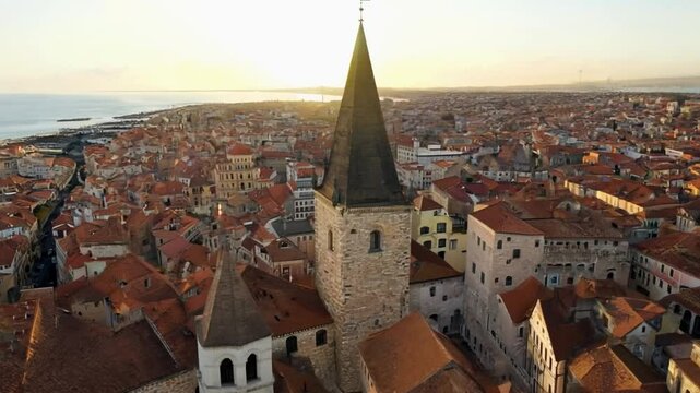 The bell tower of saint justus cathedral dominating pula skyline at sunset