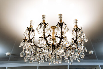 An intricately designed and ornate chandelier gracefully hangs from the high ceiling of the...
