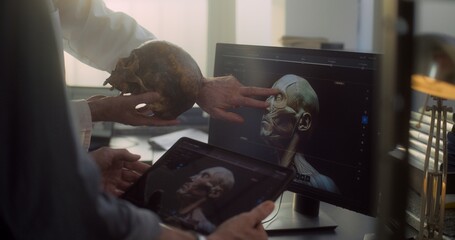 Modern archaeological lab: Two scientists analyze fossil skull, discuss three dimensional model and...