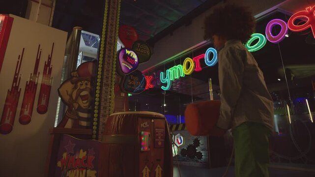Two Children playing whack and win in the amusement park