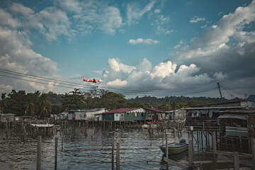 Fishing village houses over the water garbage poor areas in Sabah province in Malaysia