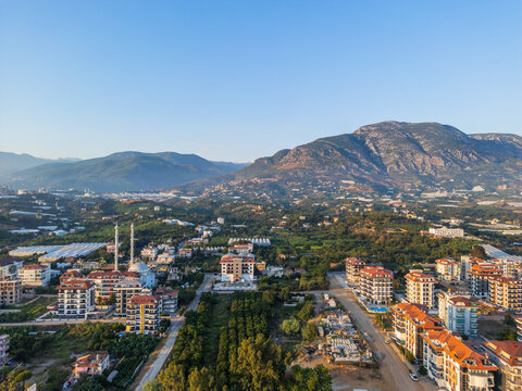 Aerial drone shot of the blue sky over the mountains and cty mosque