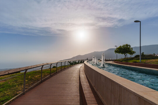 water fountain on a mountain during sunset, blue clouds