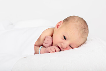 Newborn baby boy in hospital cot