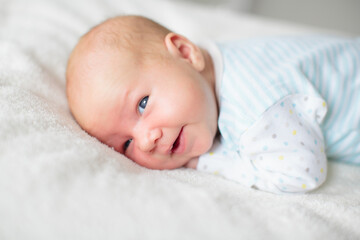 Little baby on white bed
