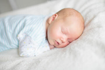 Little baby on white bed