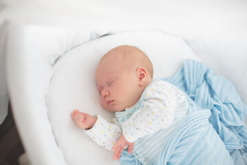 Little baby on white bed