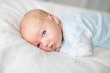 Little baby on white bed