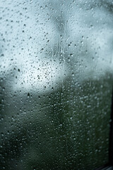 view through the raindrop window on rainy day in vertical