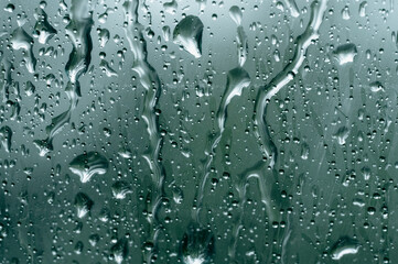 Blurred image, raindrop on the windshield, car windshield view, background bokeh.