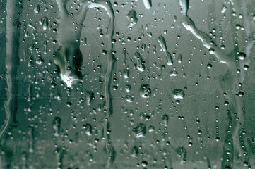 raindrops slowly dripping down the glass