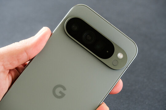 Close-up of the Google Pixel 9 Pro XL in Hazel Green, focusing on the advanced triple camera, held in hand, Stafford, United Kingdom, August 22, 2024.