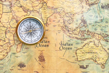 Classic round compass on background of old vintage map © yarbeer
