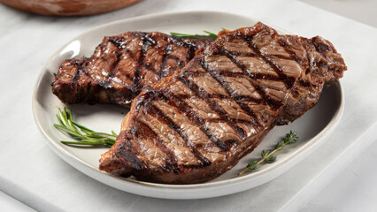 Closeup of a dish of strip steaks.