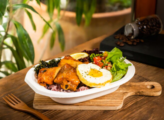 Grilled Chicken Leg Steak Dinner Box with fried egg, rice, lemon, herbs and salad served in dish isolated on table side view of taiwan food
