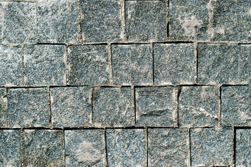 Stone texture. Old stonework. Garden wall. The streets of the old city are paved with stones.