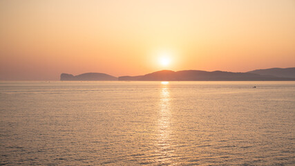 Seascape view with an intense sunset that create a golden atmosfere over the sea